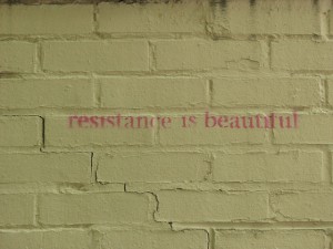 Reistance is beautiful stenciled on a brick wall