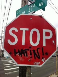 stop sign modification graffiti adding "hatin !" under the sign printed STOP