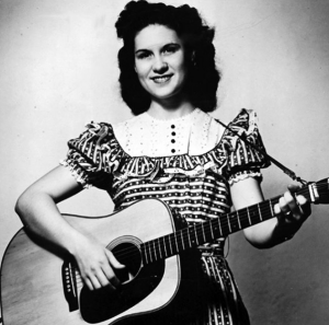 Picture of female country vocalist Kitty Wells with her guitar