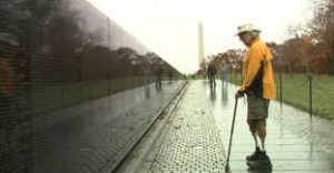 S. Brian Willson in front of the Vietnam Veterans Memorial Wall