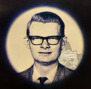 A stock photo of a square-looking 1950s white man (supposed to be Brother Russell) with the Self Help Radio logo behind it.