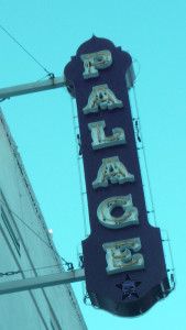 A vertical sign that says Palace with the Self Help Radio logo added at the bottom.
