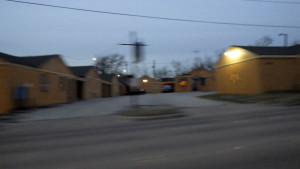 An image of a motel at night with the Self Help Radio logo where the no vacancy sign might be.