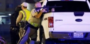 Officials Hiding Behind a White Truck