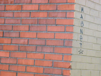 It's a picture of a wall with the word MAGNET written on it & the Self Help Radio logo next to that.