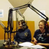 4 Comedians sitting and laughing during a radio show program